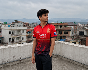 Sreeju wearing a red and black custom football jersey on a rooftop